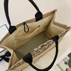 Detail view of the linen tote bag interior showing the zipper pocket and large capacity