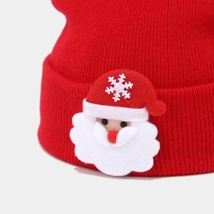 Red knit Christmas hat with cute Santa Claus patch and snowflake detail for winter