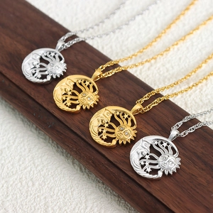 Elegant gold and silver crescent moon necklaces with inlaid rhinestones on a wooden base