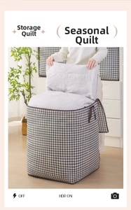 Detail showing high capacity houndstooth storage bag with person placing a folded duvet inside