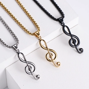 Macro shot of treble clef music necklaces in gold, silver and black on display