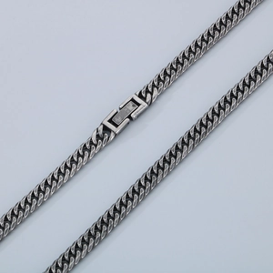Macro shot of silver titanium steel interlocking clasp on retro Cuban chain link necklace