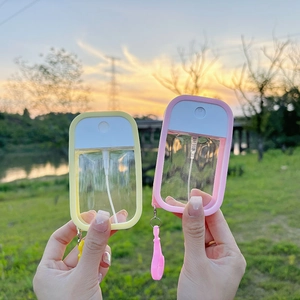 Portable macaron spray bottles in yellow and pink for travel alcohol and perfume