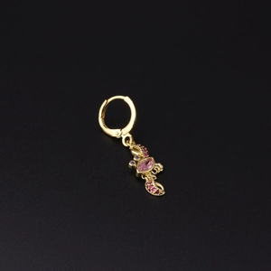 Macro detail of gold earring with scorpion pendant set with pink and purple zircon stones