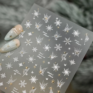 Winter snowflake and butterfly nail art stickers in white and gold metallic finish