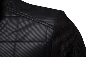 Detailed close-up of men's black jacket with diamond quilting and honeycomb knit texture