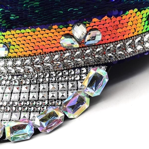 Macro detail of military party hat with colorful sequins and large iridescent rhinestones