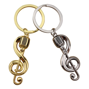 Creative music themed keychain with gold and silver microphone and treble clef charms