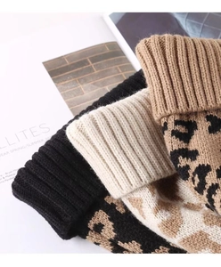 Detailed knit texture of leopard print beanies showing soft fabric and ribbed cuffs