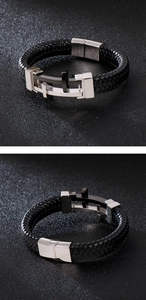 Detail of woven leather men's bracelet with a stainless steel cross and magnetic clasp
