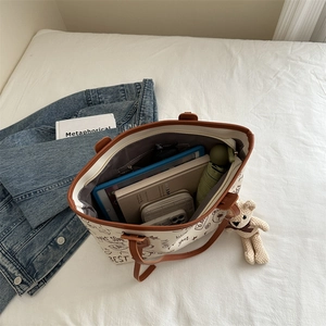 Large canvas tote bag with bear print and brown leather straps for daily commute