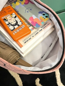 Interior view showing large capacity of the pink corduroy backpack with organized pockets