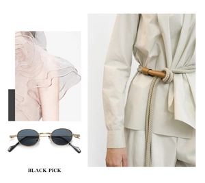 Detail of round vintage sunglasses with black lenses and metallic frames in fashion context