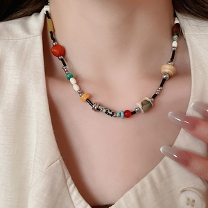 Detail of colorful bohemian beaded necklace with mixed wood and stone resin beads