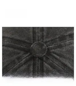 Top macro view of a black corduroy baseball cap showing reinforced stitching and eyelets