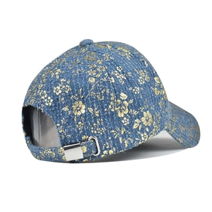 Close-up of hip hop baseball cap with gold floral print and adjustable metal buckle