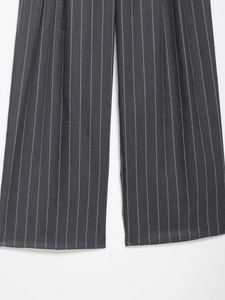 Detailed macro view showing the gray striped fabric texture of these elegant trousers
