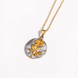 Minimalist titanium necklace with gold rose relief on a hammered silver pendant