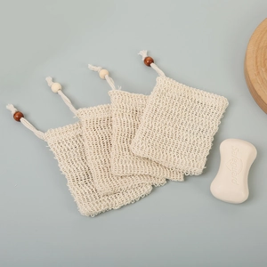 Detail of four natural sisal soap saver bags with drawstring and wooden beads