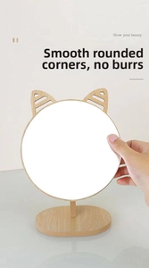 Detail of round wooden vanity mirror with smooth burr-free edges and cute cat ear design