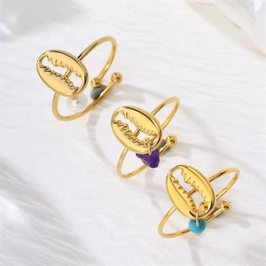 Bohemian gold shell rings set with pearls and natural stones on white fabric