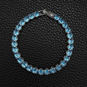 Detail view of hip hop tennis bracelet with blue square-cut zircons on black leather