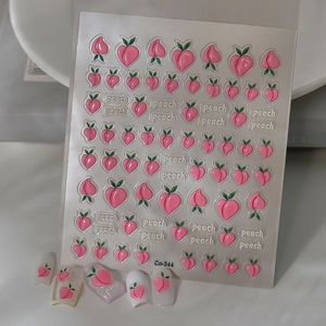 Close-up of 3D embossed peach nail stickers and finished nails with cute fruit design