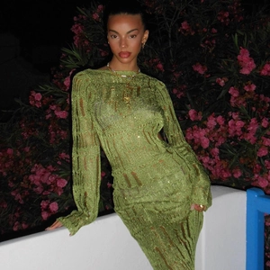 Close-up of green hollow-out knit dress showing delicate texture and bodycon fit