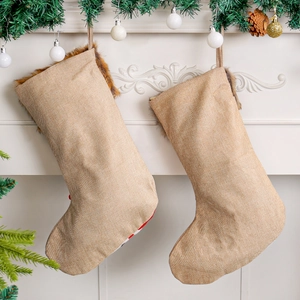 Festive beige linen Christmas stockings with faux fur trim hanging on fireplace mantel
