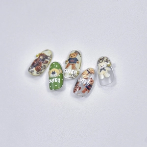 Detail of cute teddy bear nail art stickers featuring green polka dots and 3D pearl accents