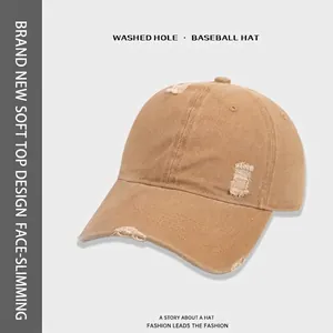 Vintage khaki washed cotton baseball cap with distressed hole details and soft top structure