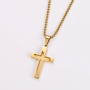 Detail of gold stainless steel cross necklace with engraved Lord's Prayer text