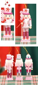 Detailed macro view of 13cm candy-themed nutcracker ornaments with pink cake and lollipop decor