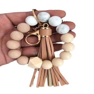 Silicone and wood beaded wristlet keychain with leather tassel and gold metal clasp