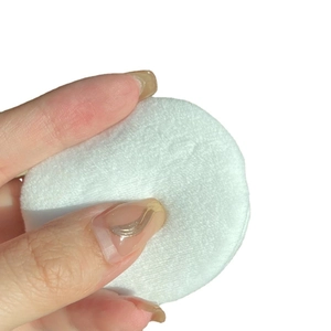 Soft cotton powder puff with plush texture for flawless setting powder application