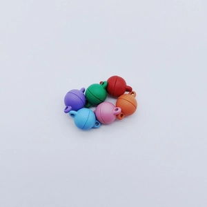 Macro detail of colorful spherical matte magnetic heart clasps for DIY jewelry making