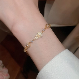 Detailed close-up of 18k gold plated gourd bracelet with white pearls and zircons