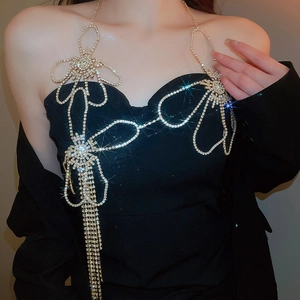 Close-up of sparkling rhinestone flower body chain with elegant tassel fringe details