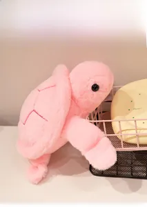 Detailed close-up of the soft pink plush turtle toy shell texture and plush fabric