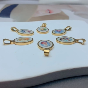 Set of six oval stainless steel Guadalupe pendants with religious icons in golden finish