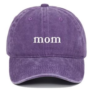 Detail of white mom letter embroidery on purple washed cotton baseball cap texture