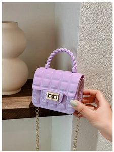 Detail of purple jelly bag featuring golden chain strap and metallic twist lock mechanism