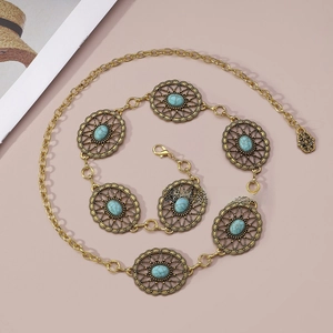 Detail of bohemian gold waist chain featuring turquoise stones and hollow floral metal disks