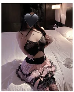 Detail of pink ruffled skirt and black lace stockings on a bedroom scene model