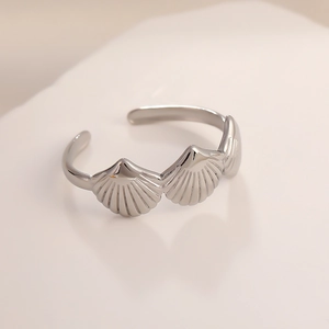 Elegant stainless steel open ring featuring a detailed seashell design with a polished finish