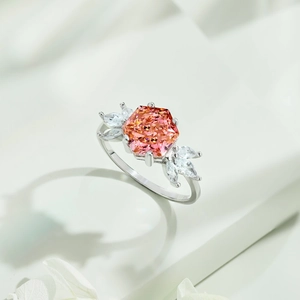 Macro shot of S925 silver ring featuring hexagonal pink orange stone and marquise crystals