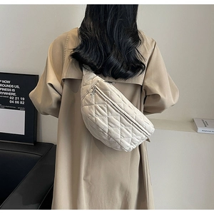 Beige quilted crossbody chest bag worn by a model in a minimalist stylish setting