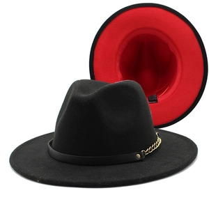 Detail of two-tone wool fedora featuring red lining and a gold chain accessory