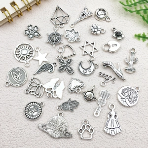 Flat lay of antique silver alloy charms including stars and Eiffel Tower for DIY jewelry