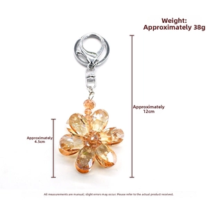 Macro detail of amber crystal flower keychain with faceted petals and silver clasp